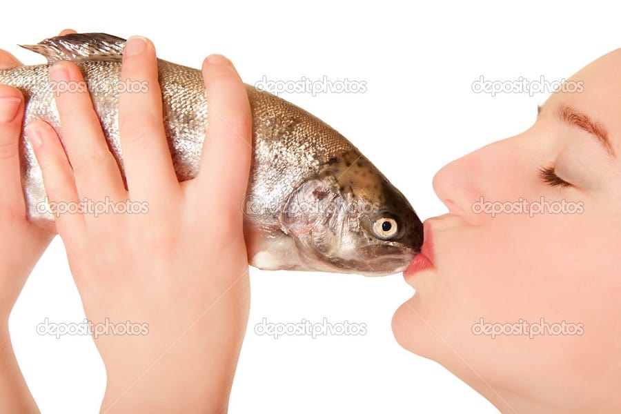 woman kissing fish weird stock photo