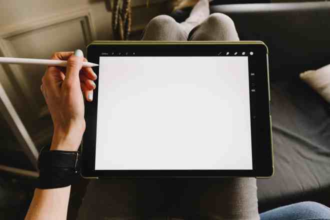 person holding ipad with pencil